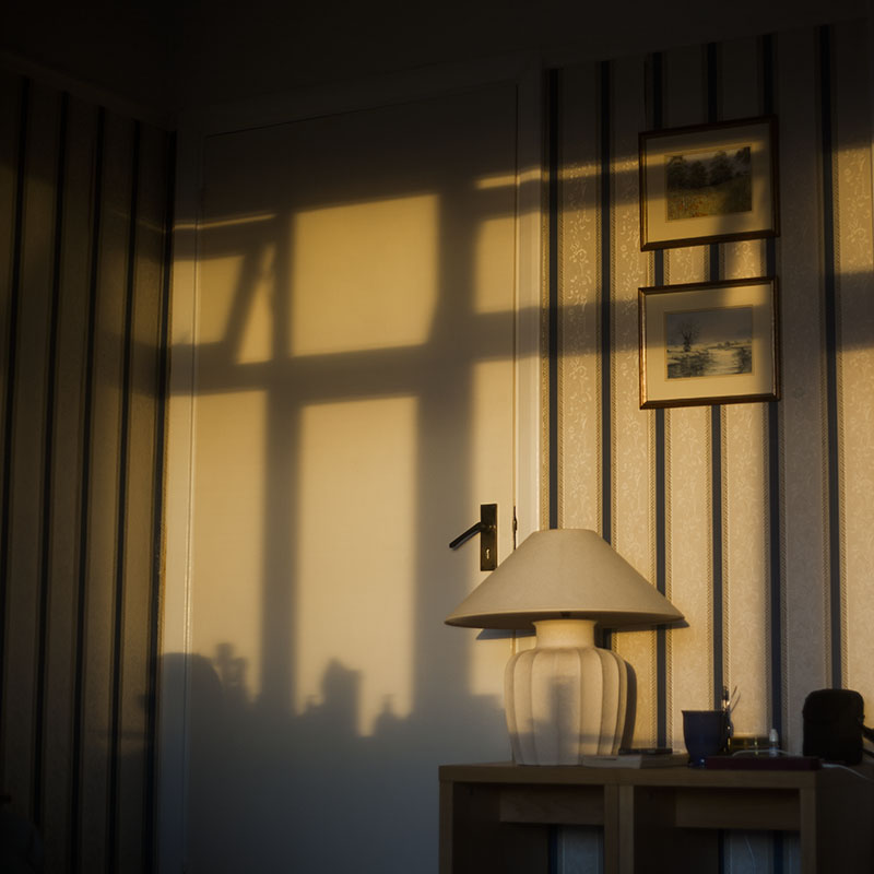 sun-setting-inside-flat-shadows-on-wall-lamp-door